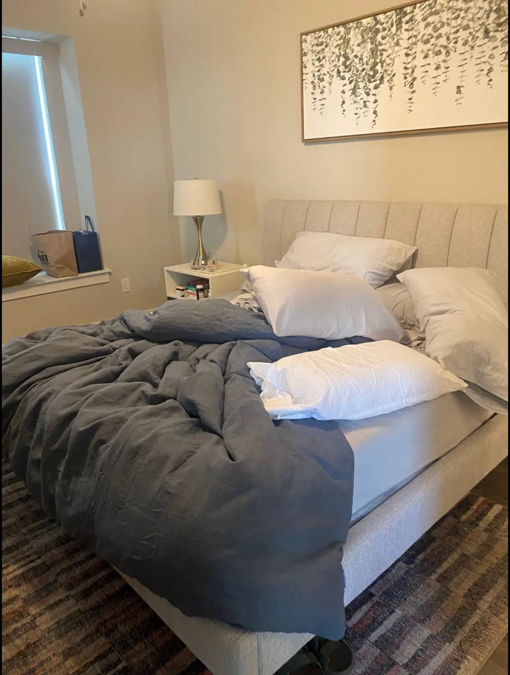 Bedroom before cleaning with unmade bedding